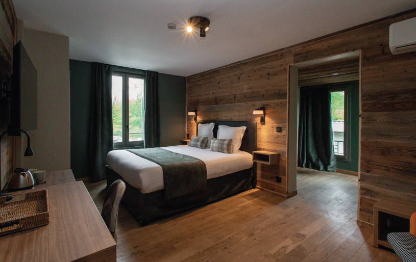 Chambre moderne avec lit double et bois naturel aux Lodges du Lac