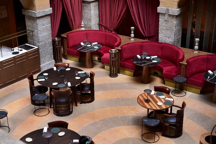 Salon lounge avec banquettes rouges à La Cour des Loges Lyon