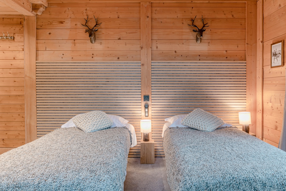 Chambre twin avec lits séparés et ambiance boisée